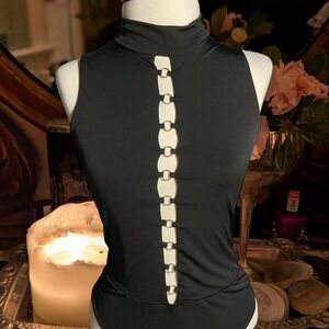 Chic and Sexy black sleeveless mock top with sultry O-ring cut out detail ✨